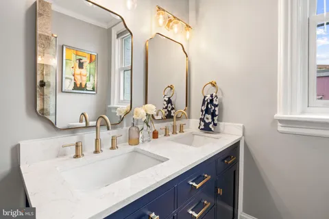a bathroom with a double vanity sink and a mirror