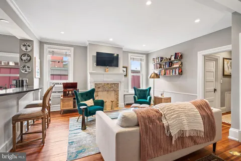 a living room with fireplace furniture and a flat screen tv