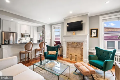 a living room with furniture fireplace and a flat screen tv