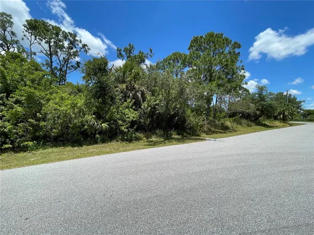 an aerial view of a residential apartment building with a yard and plants