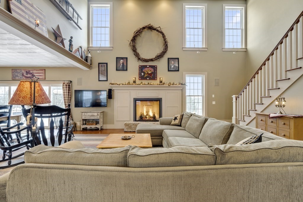 35 Piasta Road Dudley, MA 01571 - Photo 13 of 42 a living room with furniture a fireplace and a large window
