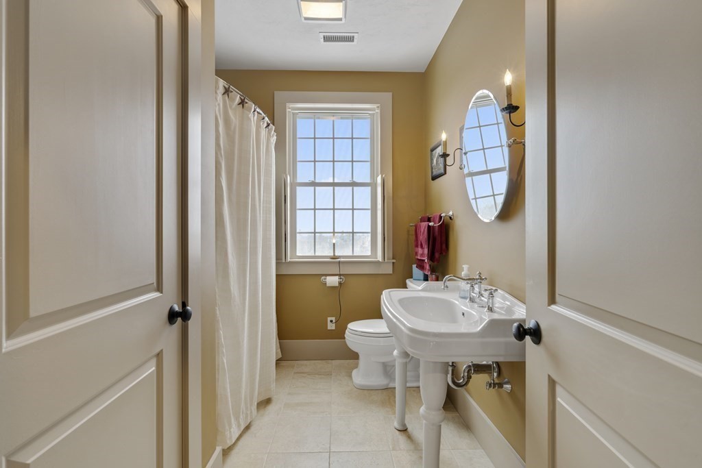 35 Piasta Road Dudley, MA 01571 - Photo 30 of 42 a bathroom with a sink mirror and a window