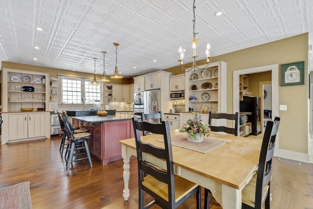 35 Piasta Road Dudley, MA 01571 - Photo 9 of 42 a dining room filled chandelier and wooden floor