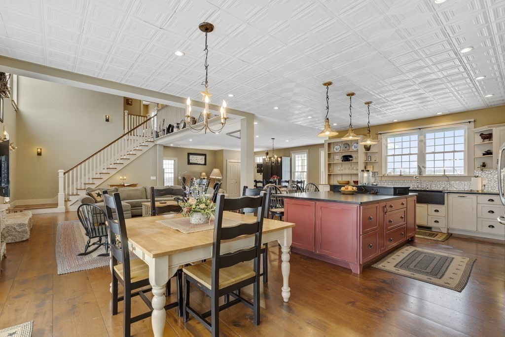35 Piasta Road Dudley, MA 01571 - Photo 10 of 42 a view of a dining room and livingroom with furniture wooden floor a chandelier