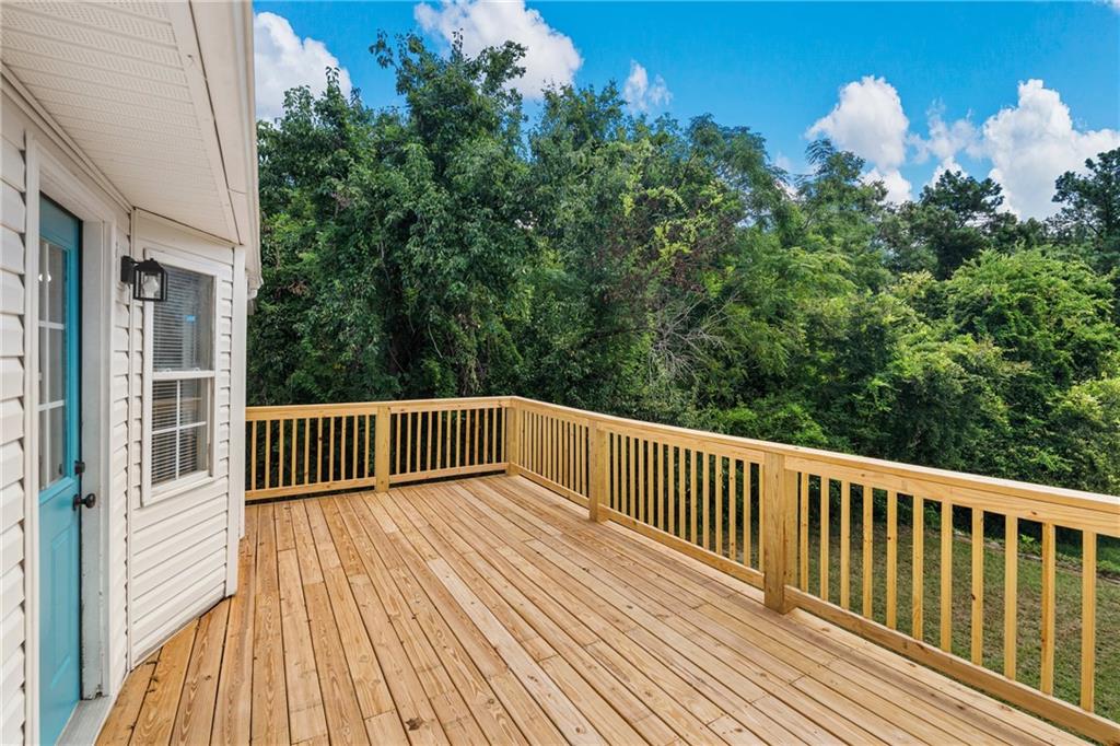 2107 South Seale Road Phenix City, AL 36869 - Photo 25 of 35 Expansive wood deck with natural wood railing, siding exterior, exterior door with glass paneling, and exterior wall lantern