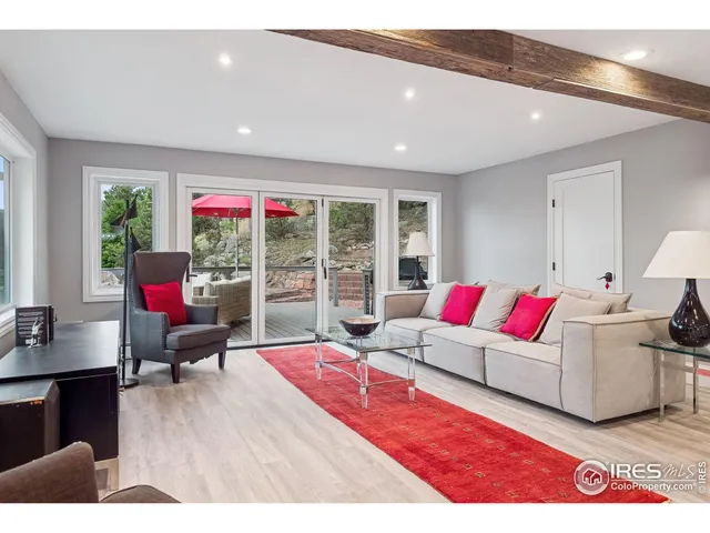 a living room with furniture window and wooden floor