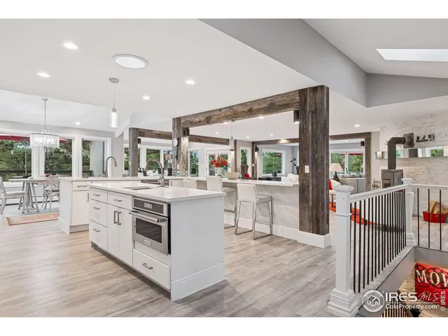 a kitchen with stainless steel appliances kitchen island granite countertop a stove top oven and sink