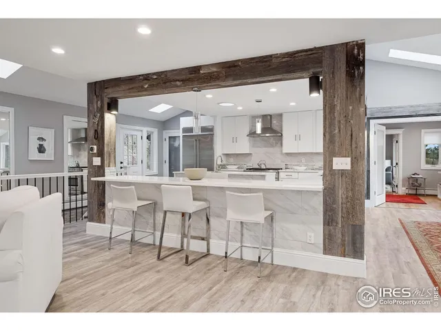 a living room with stainless steel appliances kitchen island granite countertop furniture and a view of living room