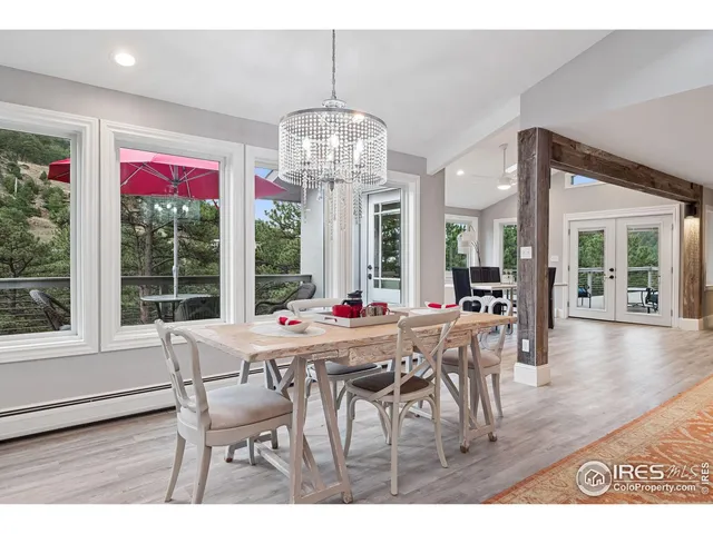 a view of a dining room with furniture wooden floor and chandelier