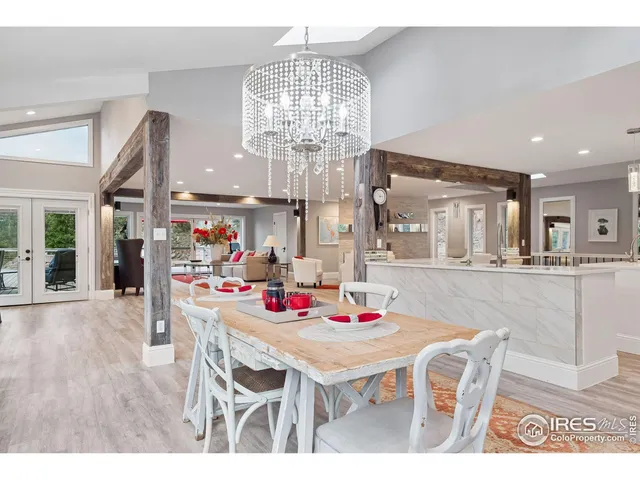 a outdoor dining space with furniture and chandelier