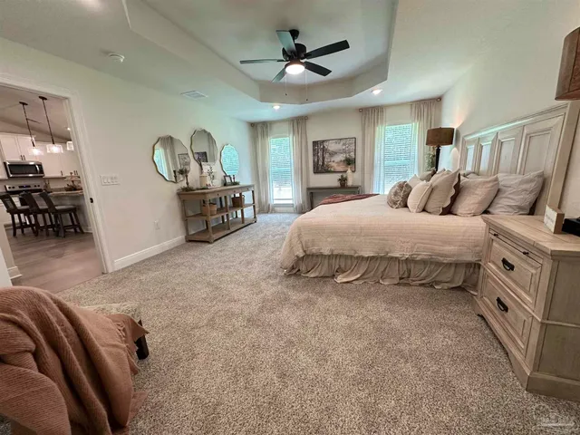 a bedroom with bed and a chandelier