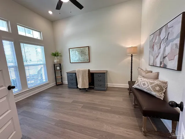 a view of an empty room with furniture and a window