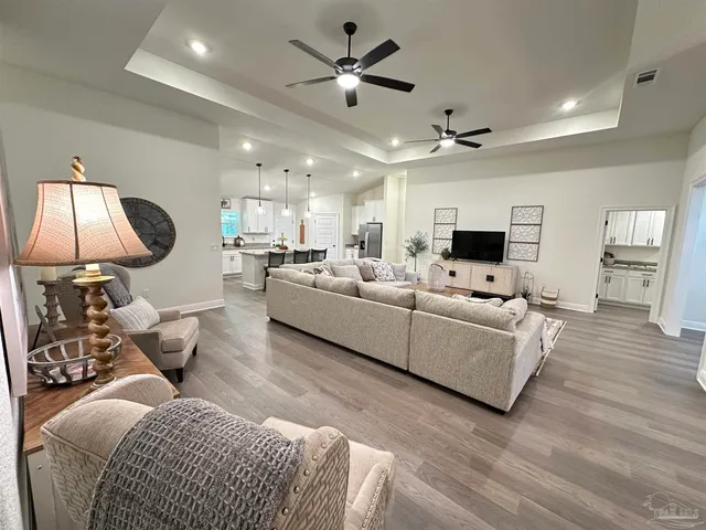 a living room with furniture and a chandelier