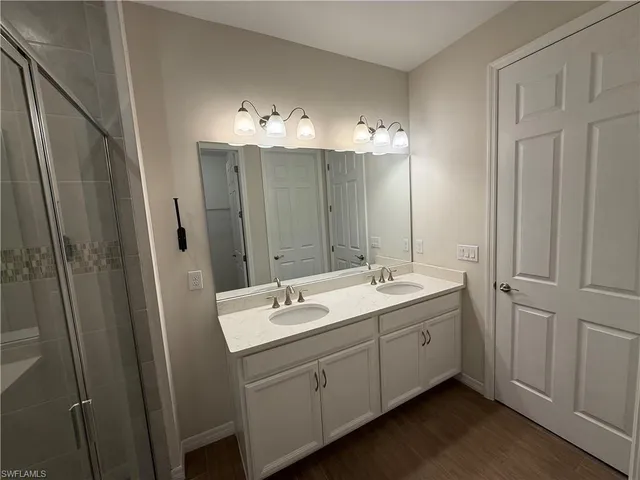 a bathroom with a double vanity sink and mirror