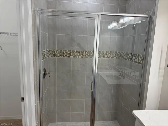 a bathroom with a glass shower door