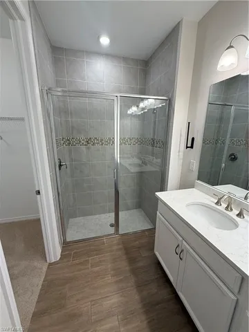 a spacious bathroom with a shower sink and toilet