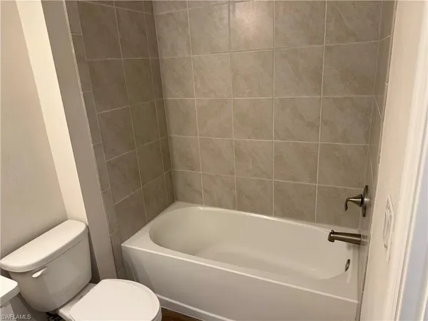 a white bath tub sitting next to a white toilet