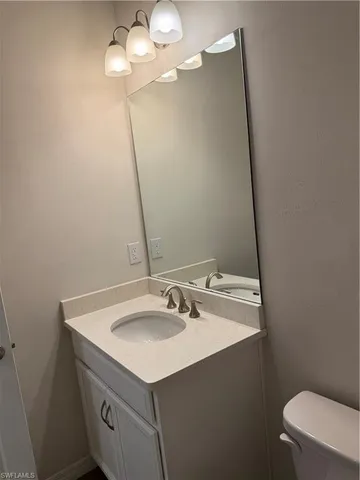 a bathroom with a sink vanity and a mirror