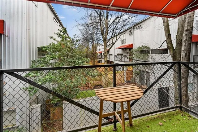 a view of a balcony with wooden benches
