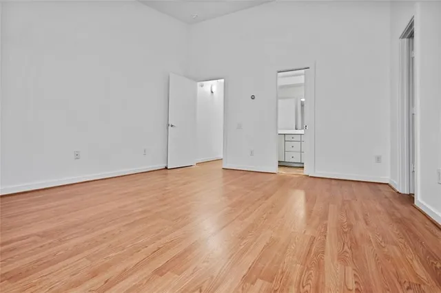 a view of an empty room and wooden floor