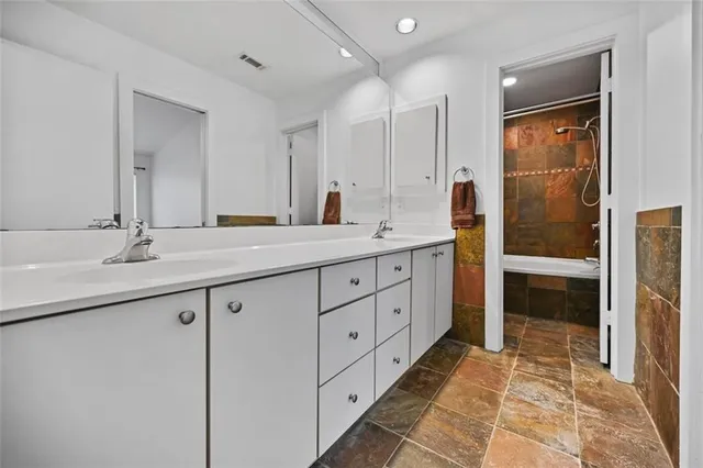 a spacious bathroom with a double vanity sink and a mirror