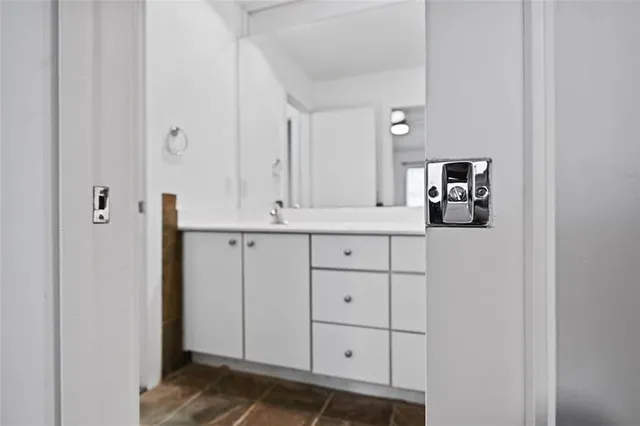 a bathroom with a sink and vanity