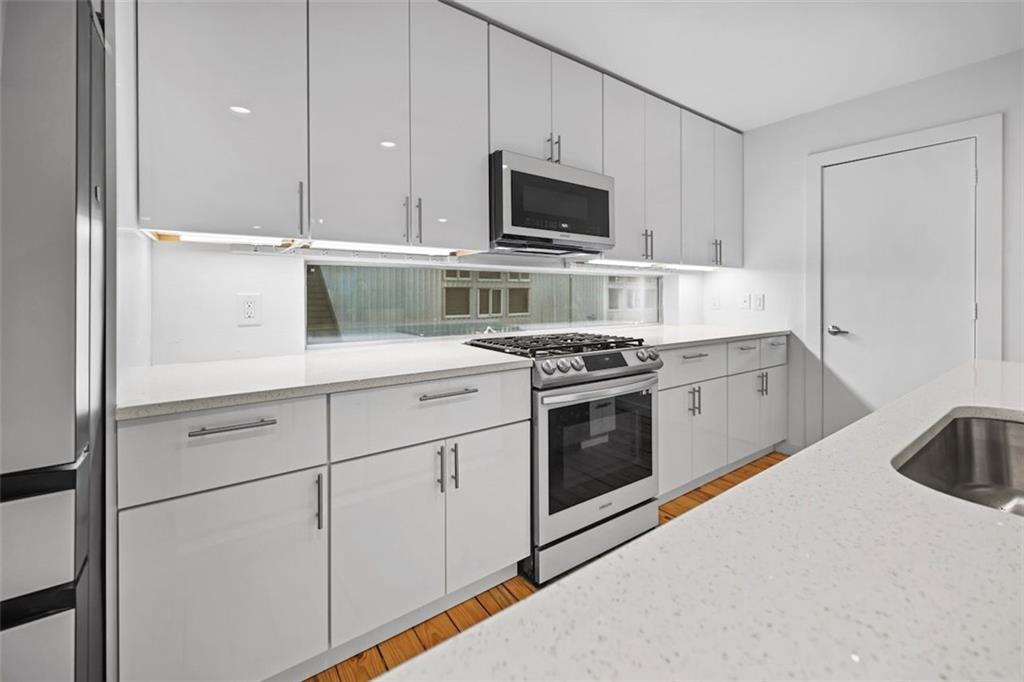 920 Memorial Drive Southeast, Unit 36 Atlanta, GA 30316 - Photo 9 of 36 a kitchen with appliances a sink and cabinets