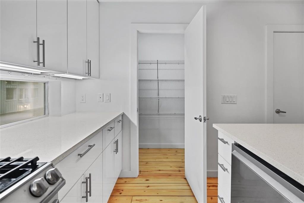 920 Memorial Drive Southeast, Unit 36 Atlanta, GA 30316 - Photo 10 of 36 a kitchen with white cabinets and white appliances