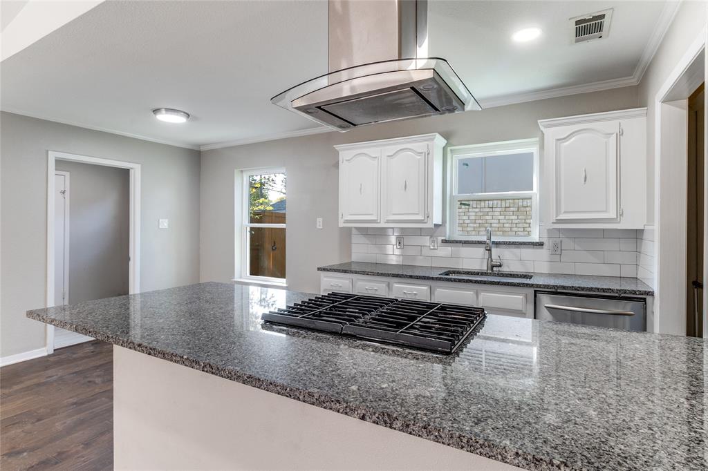 11236 Quail Run Street Dallas, TX 75238 - Photo 11 of 25 a kitchen with stainless steel appliances granite countertop a stove a sink and a granite counter tops