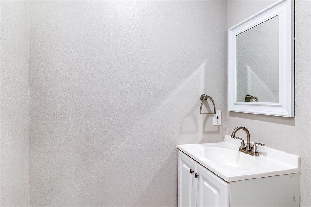 11236 Quail Run Street Dallas, TX 75238 - Photo 23 of 25 a bathroom with a sink and mirror