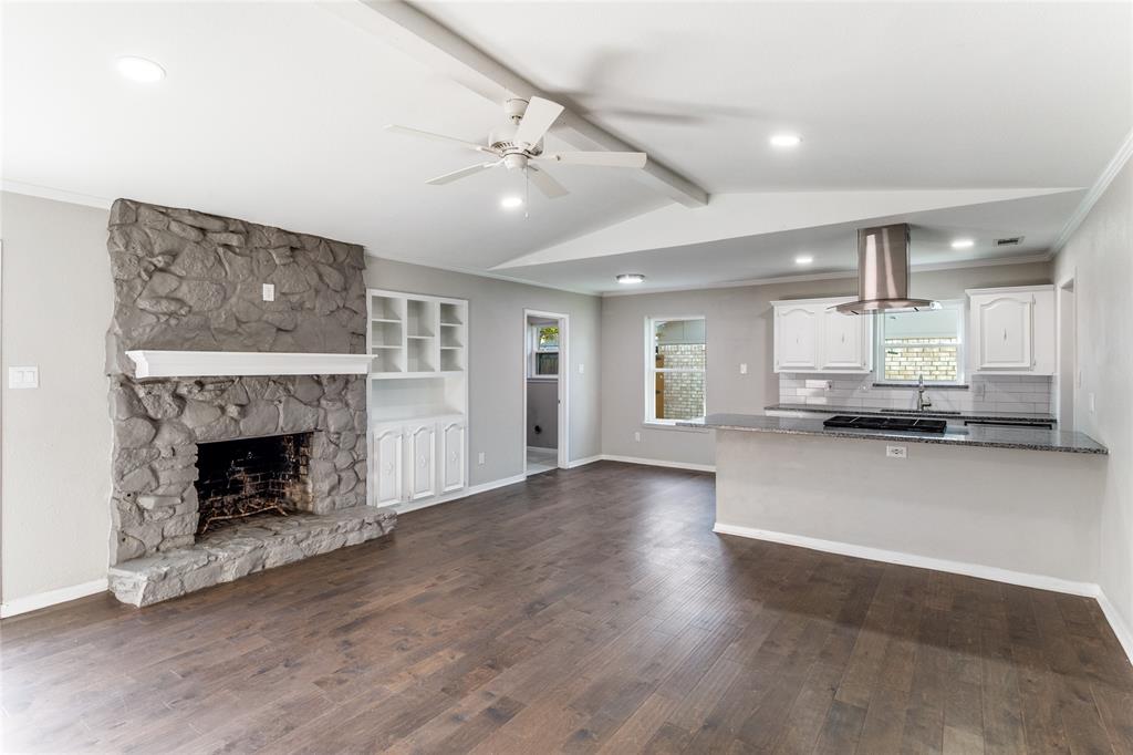 11236 Quail Run Street Dallas, TX 75238 - Photo 4 of 25 a view of an empty room with a fireplace