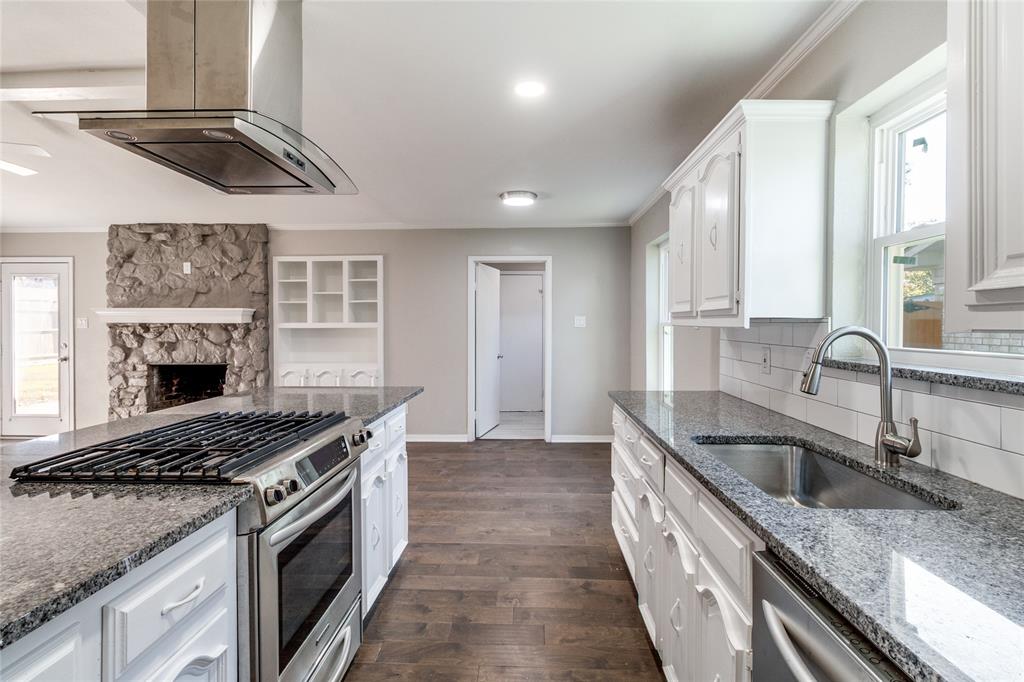 11236 Quail Run Street Dallas, TX 75238 - Photo 9 of 25 a kitchen with stainless steel appliances granite countertop a sink a stove and a refrigerator