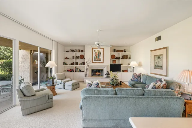 a living room with fireplace furniture and decor