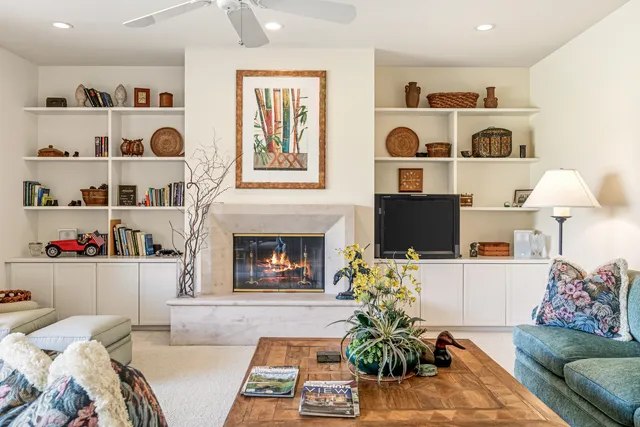 a living room with furniture and a fireplace