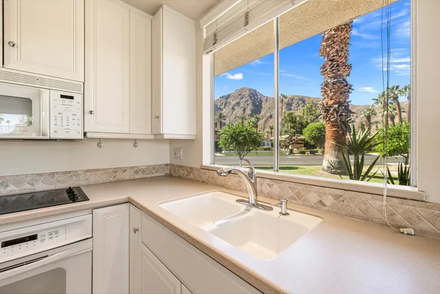 a kitchen with a sink and large window