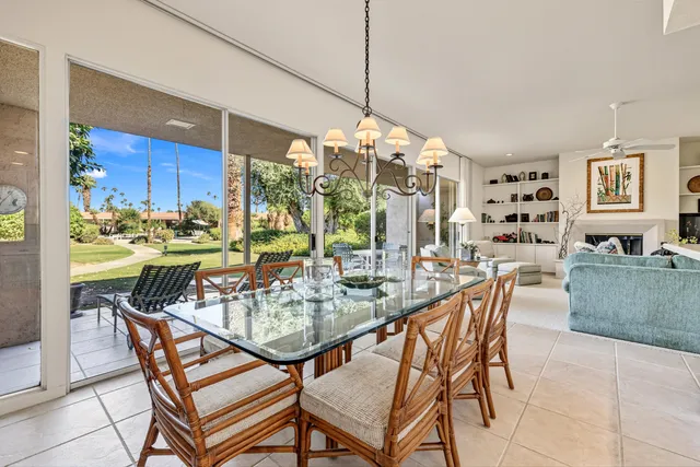 a view of a dining room with furniture and chandelier