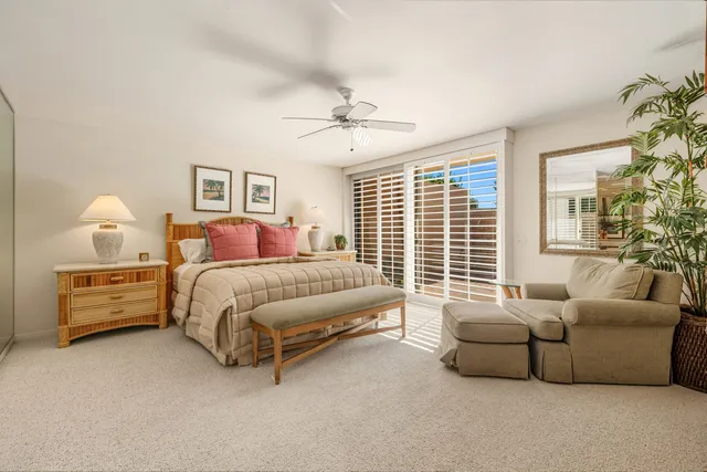 a bedroom with bed and a large window
