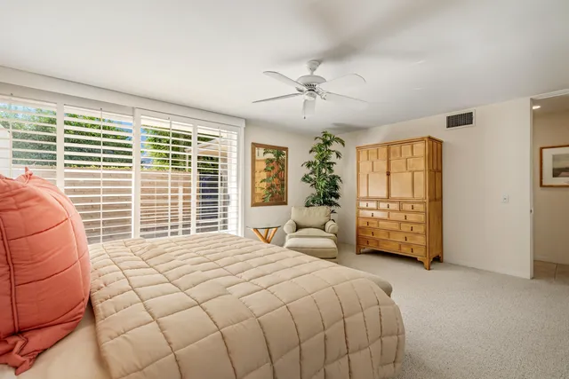 a bedroom with a large bed and a large window