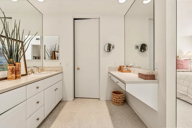 a bathroom with a double vanity sink a mirror and shower