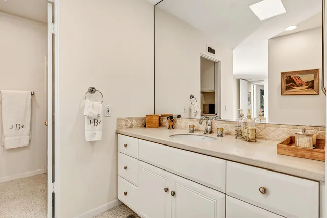 a bathroom with a double vanity sink and mirror