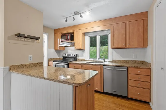 a kitchen with a sink stove and cabinets