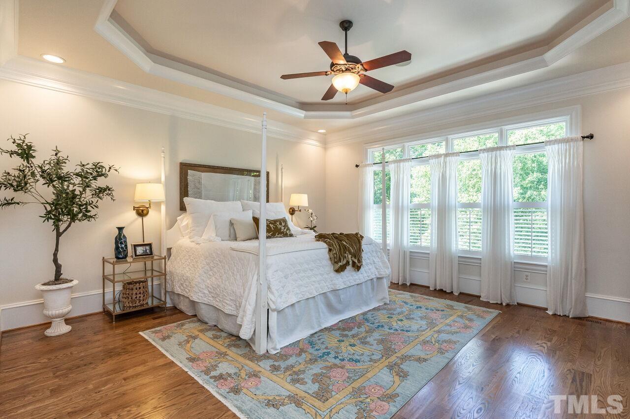 2808 Peachleaf Street Raleigh, NC 27614 - Photo 54 of 76 a bed room with a large bed and a chandelier