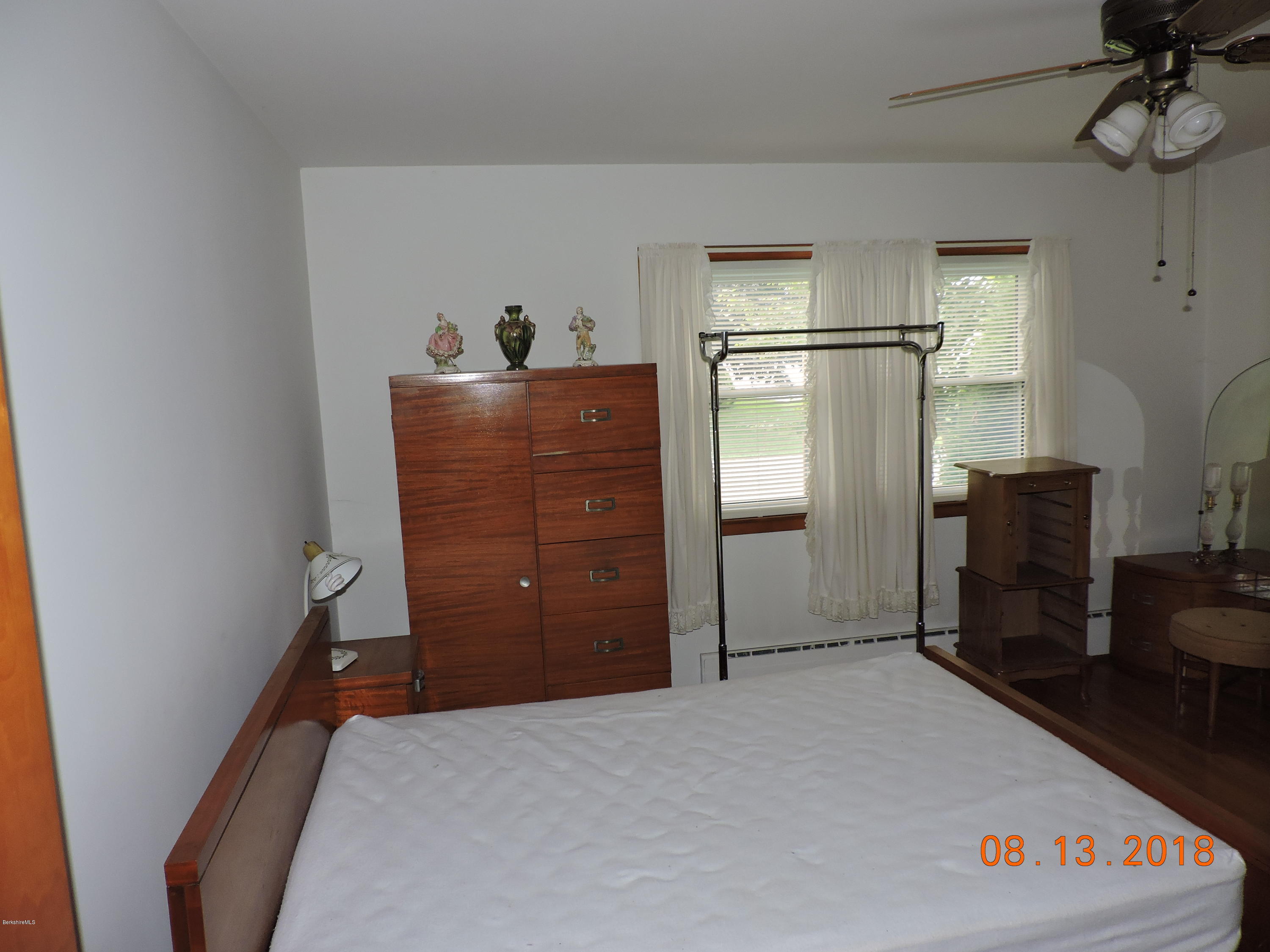 14 Calumet Street Pittsfield, MA 01201 - Photo 13 of 26 a hallway with a refrigerator and a dresser