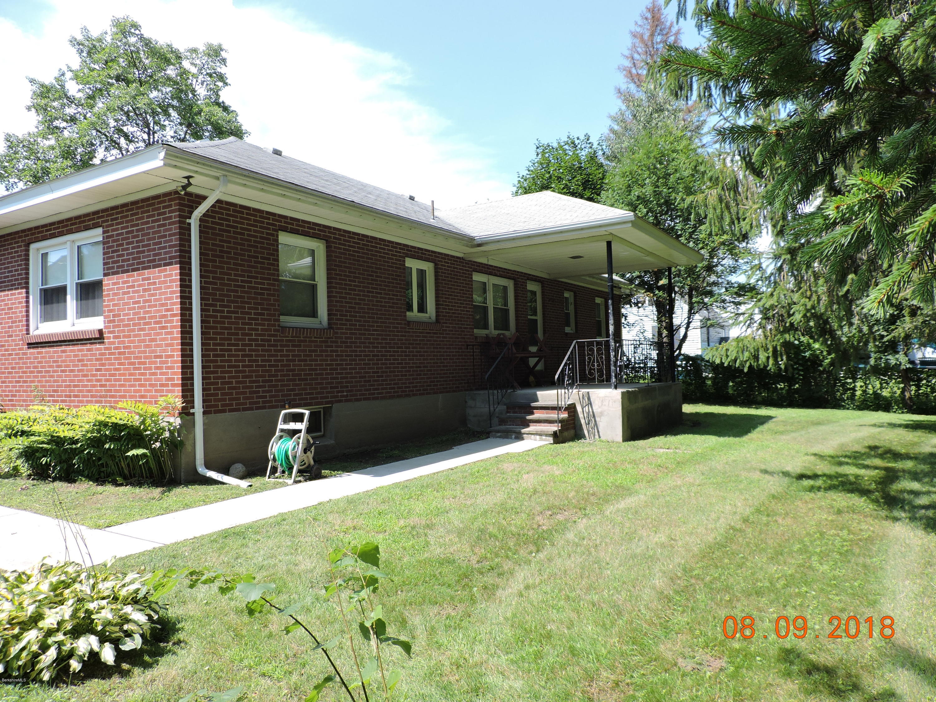 14 Calumet Street Pittsfield, MA 01201 - Photo 3 of 26 a backyard of a house with yard and outdoor seating