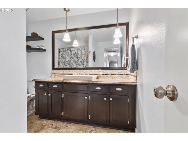 a bathroom with a sink vanity and a mirror