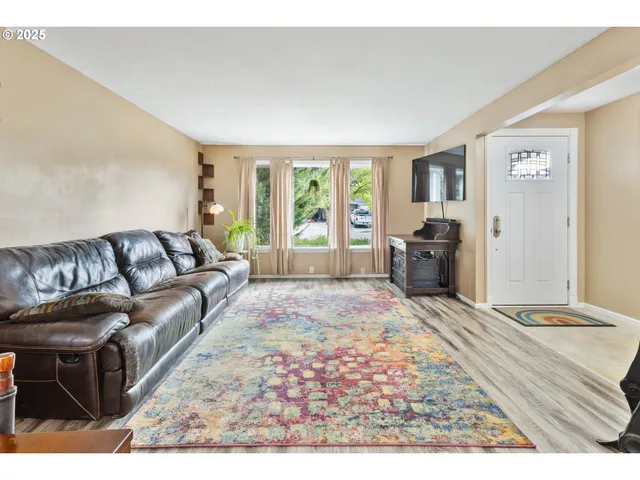 a living room with furniture window and wooden floor