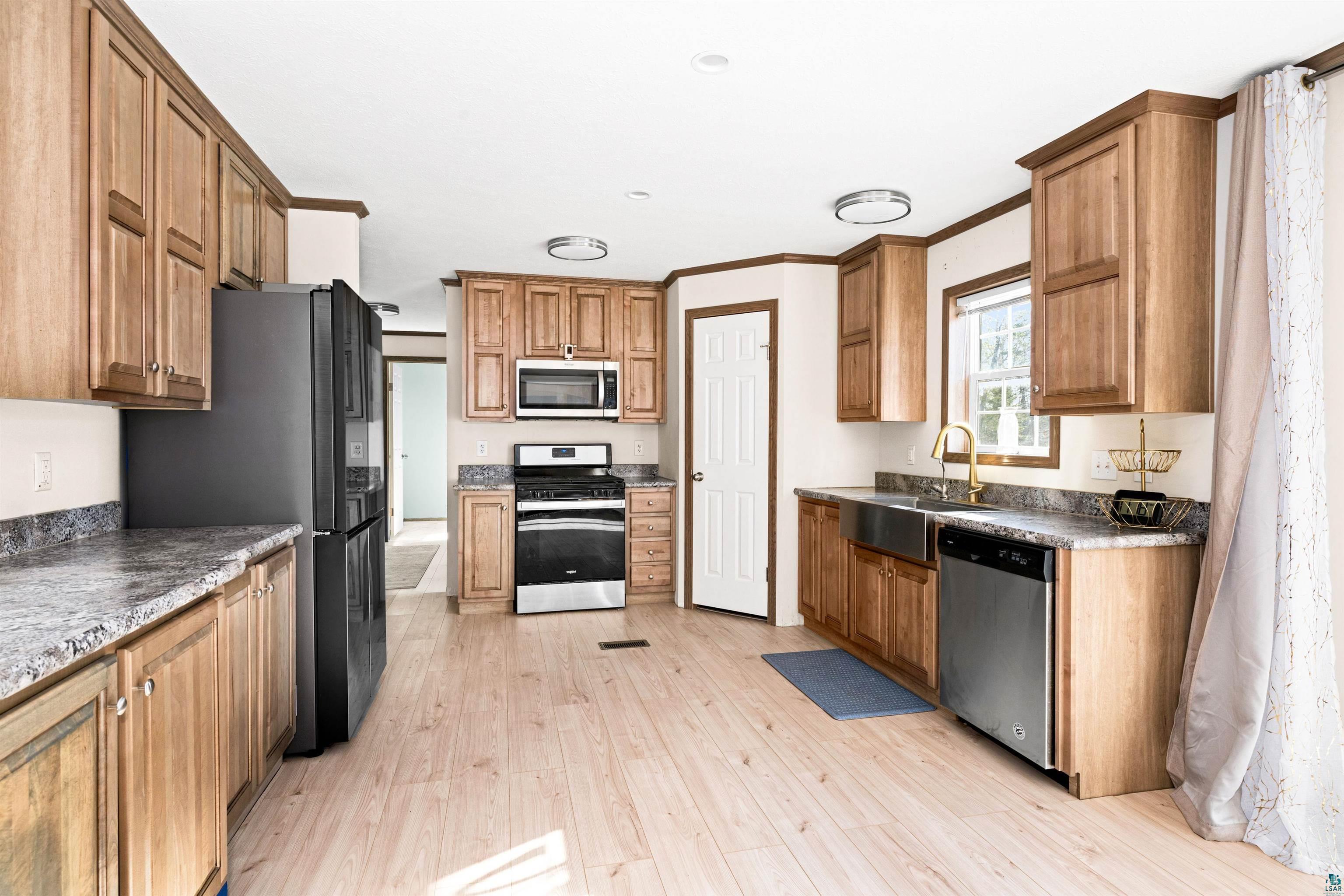 5562 Lavaque Road Duluth, MN 55803 - Photo 11 of 28 Kitchen featuring ornamental molding, sink, light hardwood / wood-style flooring, and stainless steel appliances