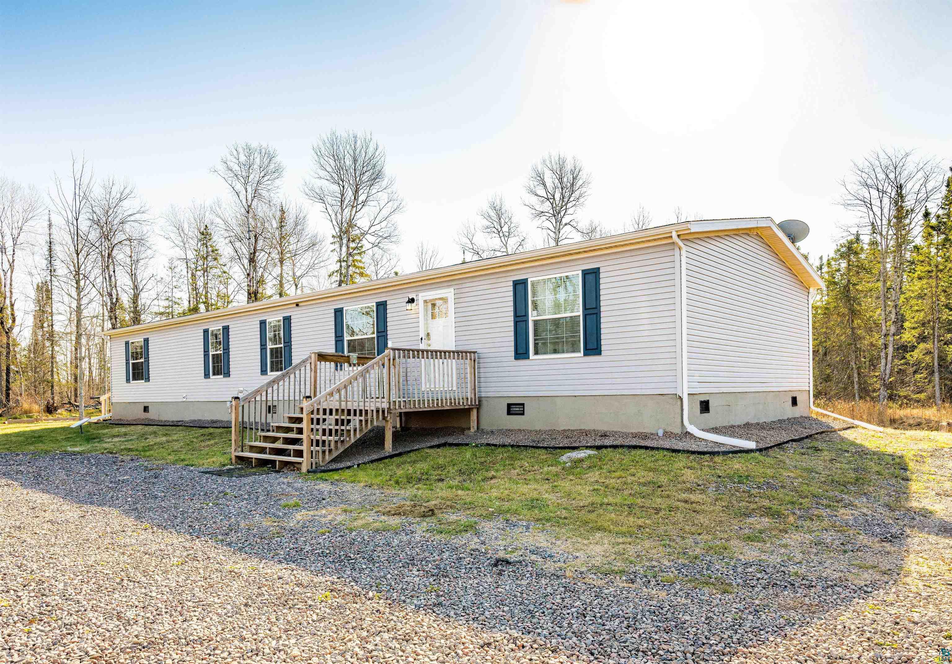 5562 Lavaque Road Duluth, MN 55803 - Photo 2 of 28 Manufactured / mobile home with a wooden deck and a front yard