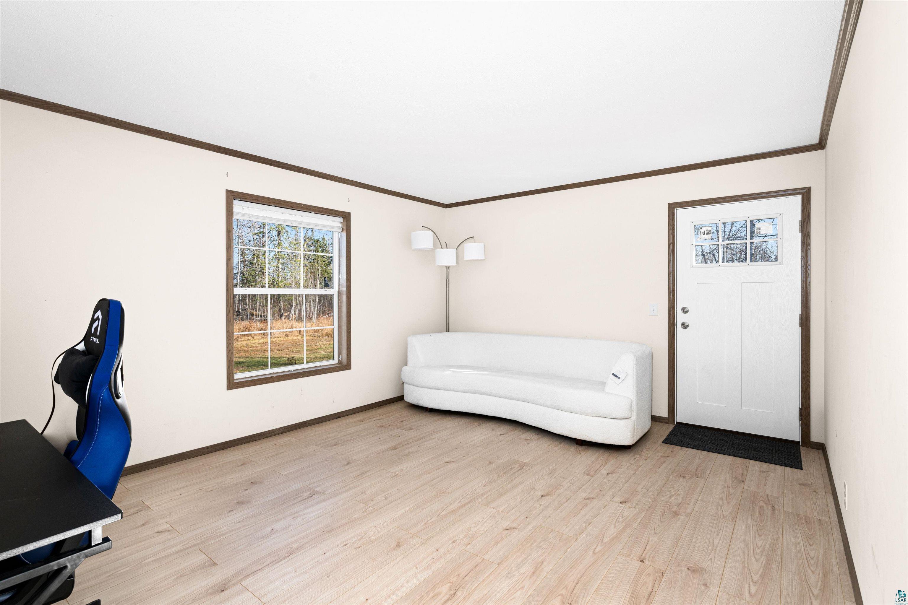 5562 Lavaque Road Duluth, MN 55803 - Photo 21 of 28 Living area with light hardwood / wood-style floors and ornamental molding