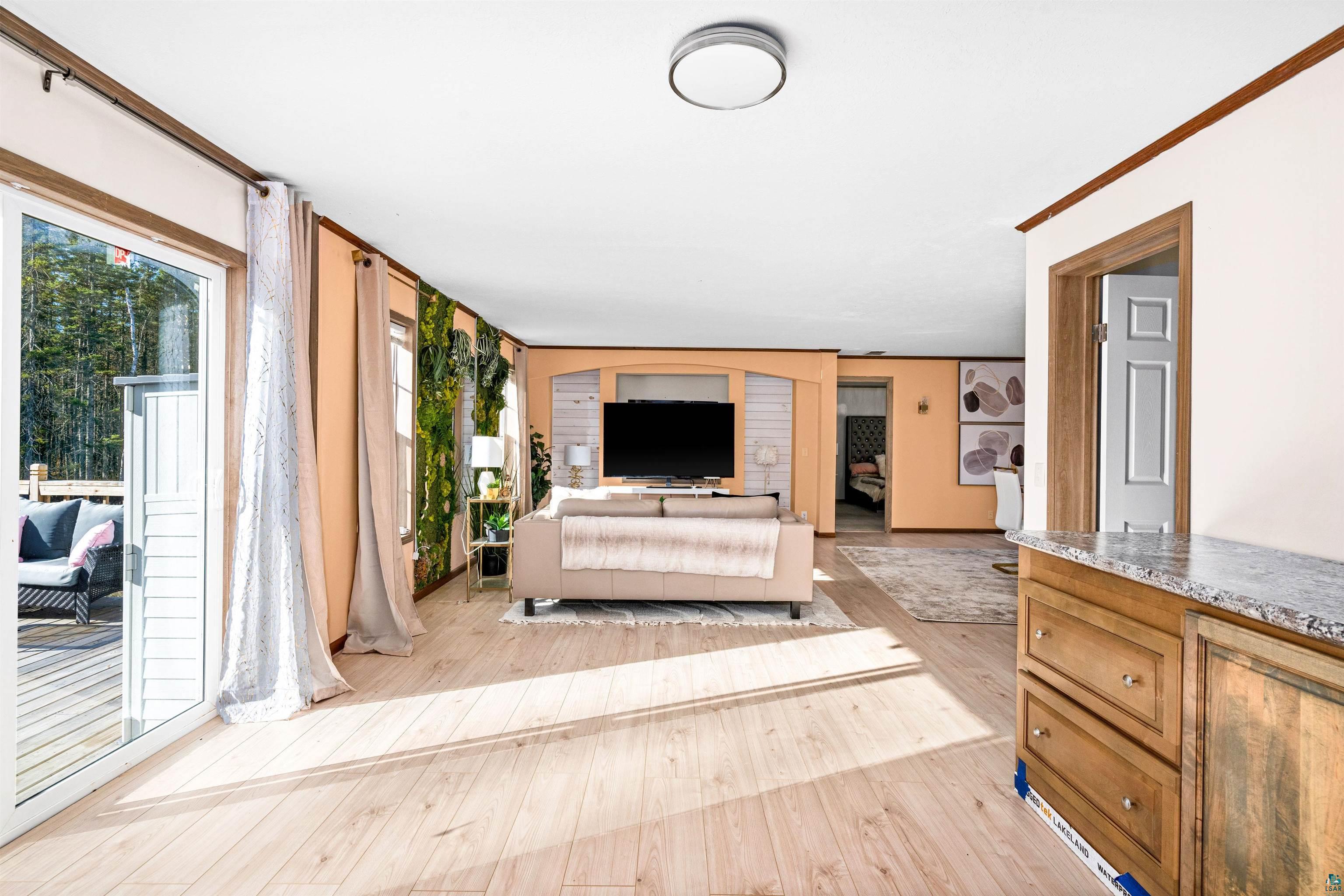5562 Lavaque Road Duluth, MN 55803 - Photo 8 of 28 Living room featuring crown molding and light wood-type flooring